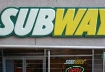 Subway sign in front of restaurant