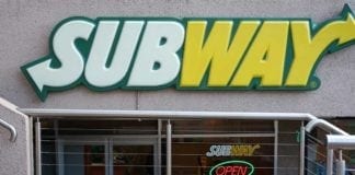 Subway sign in front of restaurant