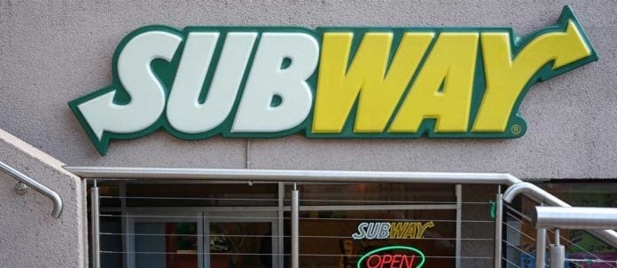 Subway sign in front of restaurant