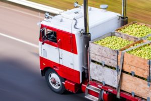 old-cab-over-big-rig-semi-truck-transporting-pears-in-wooden-boxes-on-picture-id1138550166