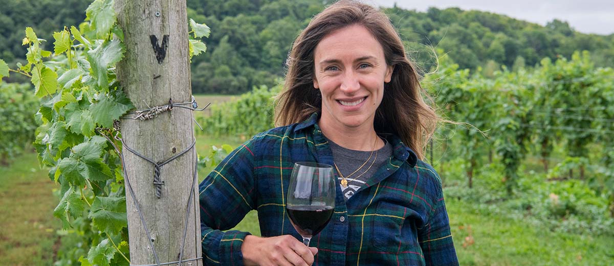 Allison Findlay in a Vineyard with a Glass of Red Wine