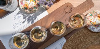 Wine glasses on a cutting board with Naramata Inn wine list underneath