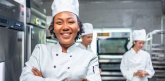 Female chef smiling in a restaurant kitchen