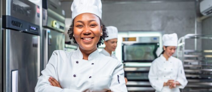 Female chef smiling in a restaurant kitchen