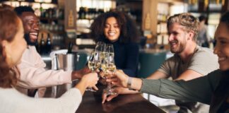 friends toasting with wine in bar