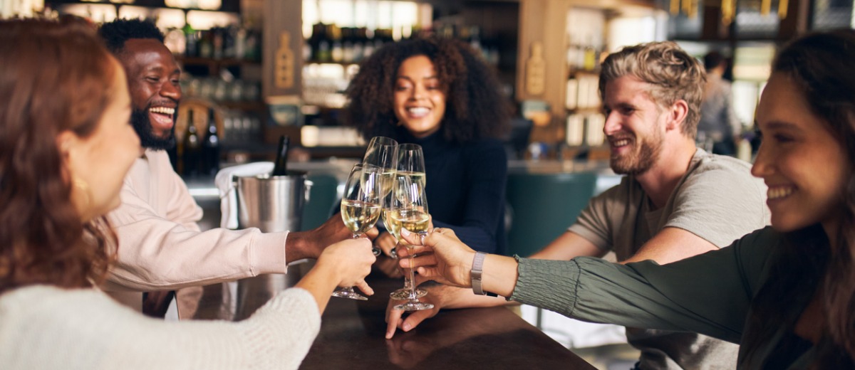 friends toasting with wine in bar