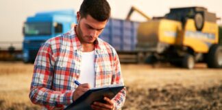 Farmer calculating crop production in a field