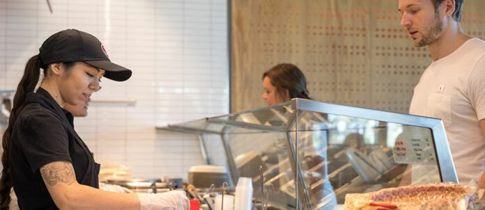 Chipotle worker making a customer's burrito