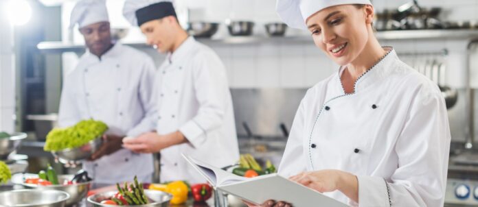 Chefs preparing a meal in a commercial kitchen