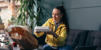 Woman at home enjoying a meal that was delivered