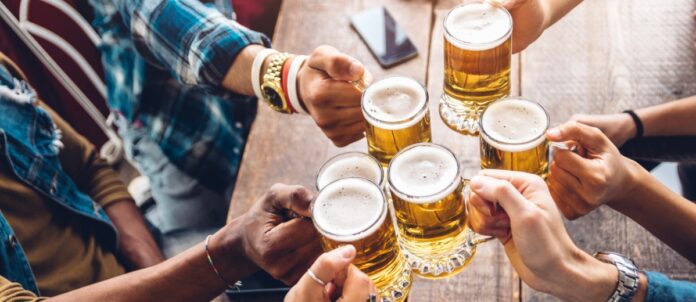 Group of friends toasting beer at a brewery pub