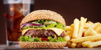 Cheeseburger with a glass of cola and french fries