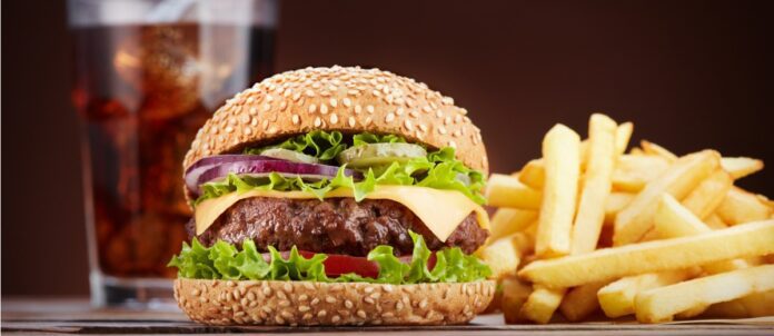 Cheeseburger with a glass of cola and french fries