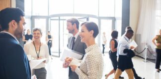 Group of business people standing and talking at tradeshow event