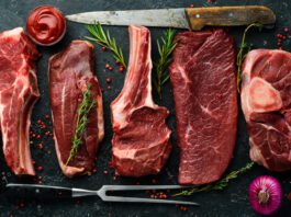 Variety of Different Steak with Knives and Vegetables around Meat