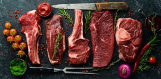 Variety of Different Steak with Knives and Vegetables around Meat