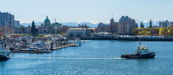 Victoria Inner Harbour. Historical buildings in the background over blue sky. Panoramic view.