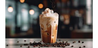 Coffee Beans around Iced Coffee with Milk, Marshmallows, and Cinnamon Flakes in Drink