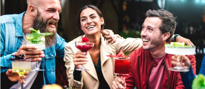 Friends drinking cocktails and margaritas together