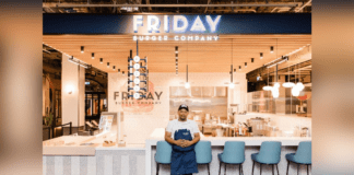 Chef Joe Friday in front of New Friday Burger Company Storefront