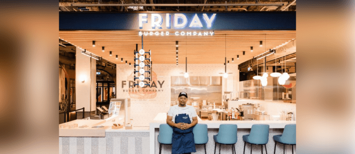 Chef Joe Friday in front of New Friday Burger Company Storefront