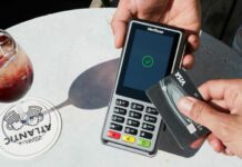 Customer using debit machine at restaurant