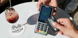 Customer using debit machine at restaurant