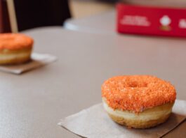 Tim Hortons Orange Sprinkle Donut on table