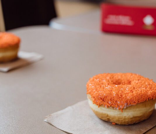 Tim Hortons Orange Sprinkle Donut on table