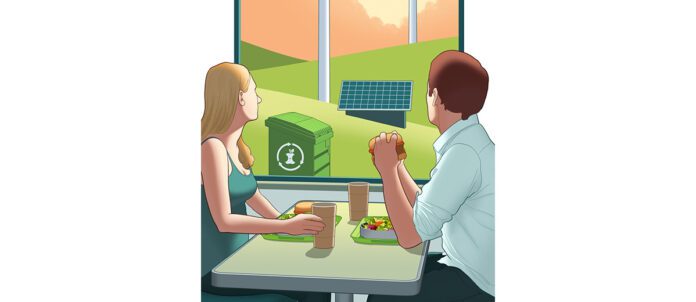 Man and Woman at Restaurant looking out window to see compost container, solar panels, and windmills