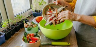 Woman chef pouring peeled apple skins into bowl