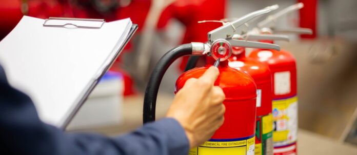 Engineer Checking Fire Extinguisher and Preforming Safety Check