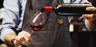 Sommelier pouring red wine into Glass