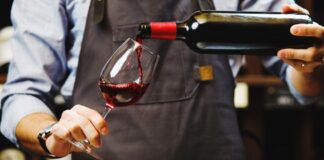 Sommelier pouring red wine into Glass