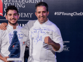 Chef Nelson Freitas holding Best Young Chef in the World Award at S. Pellegrino Young Chef Academy 2023 event