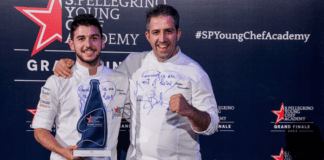 Chef Nelson Freitas holding Best Young Chef in the World Award at S. Pellegrino Young Chef Academy 2023 event