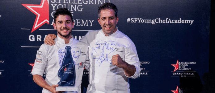 Chef Nelson Freitas holding Best Young Chef in the World Award at S. Pellegrino Young Chef Academy 2023 event