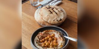 Bar Haifa Pita bread beside bowl of Hummus