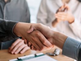 Business people shaking hands during a meeting.