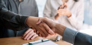 Business people shaking hands during a meeting.