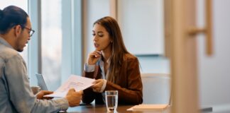 HR Manager going through legal documents with male candidate