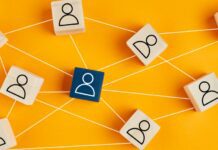 Wooden blocks with people icon on yellow background