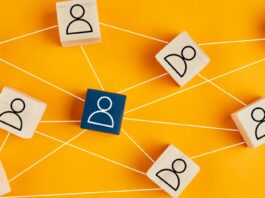 Wooden blocks with people icon on yellow background