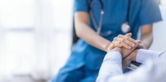 nurse holding a patients hand