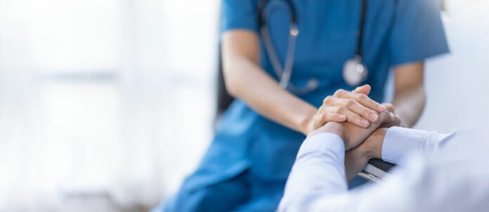 nurse holding a patients hand