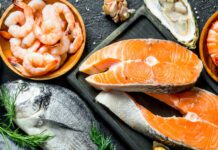 Fresh salmon steak with a variety of seafood and herbs.