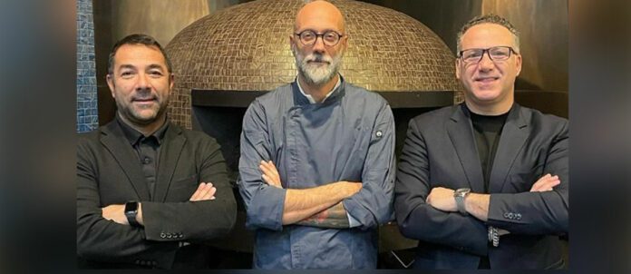 Co-owners of Marra Forni Enzo Marra, left, COO, and Francesco Marra, right, CEO, with Giulio Adriani, center, their new CPO, in their Culinary Center in Beltsville, Maryland