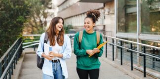 University students walking out school building together