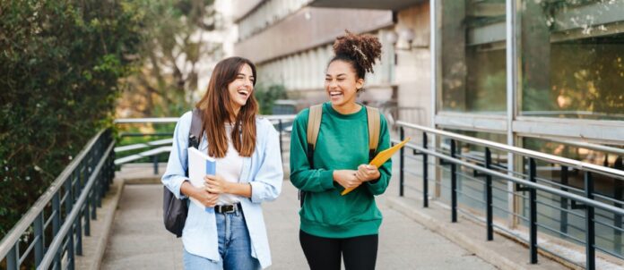 University students walking out school building together