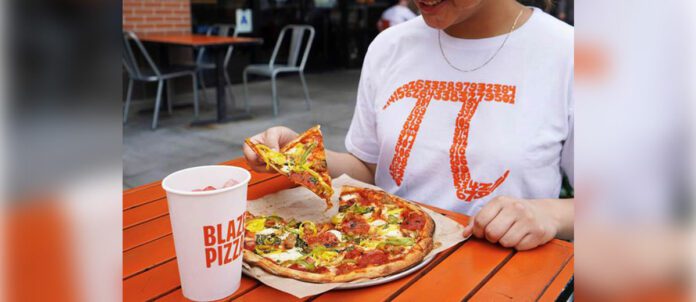 Blaze Pizza customer enjoying pizza on Pi Day